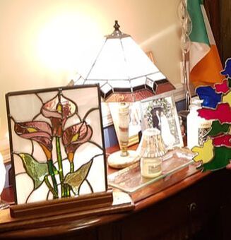 Michael with the 2019 stained glass project - purple lilies, next to the pink and purple table lamp.