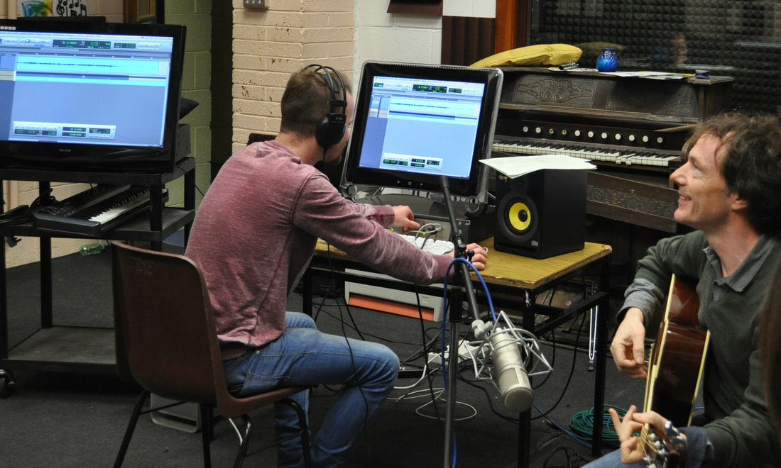 JJ Vernon, sound engineering tutor in The Donahies Community School, pictured playing the guitar in the recording studio