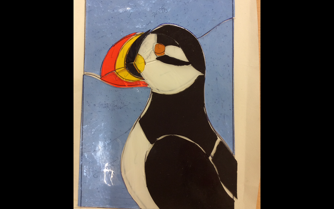 Fiona is working on a puffin in the Stained Glass class.